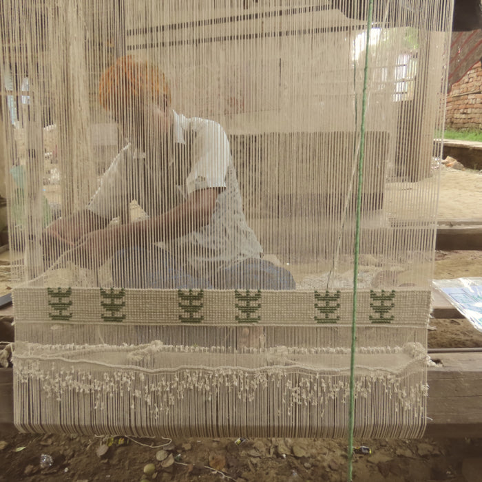 Pequra artisan crafting a handmade carpet