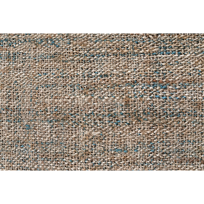 Close-up texture of PEQURA handmade jute rug showing natural beige woven fibers